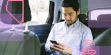 Man in the backseat of a rideshare car.