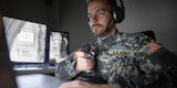 An army officer operating a robotic tank.