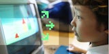 A child uses an early blue iMac.