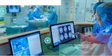 Medical staff observing a surgery via brainscans, a live feed, and an observation deck at the same time.