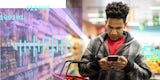 A man checks his grocery list on his smartphone.