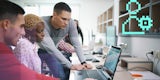 Young professional colleagues collaborate over a laptop computer.