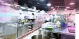 A busy restaurant kitchen with overlay of data being captured and monitored at the stoves, prep areas.